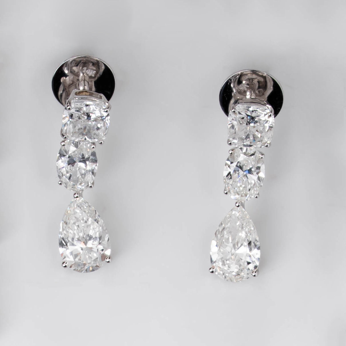 DROP EARRINGS WITH COMBINATION OF CUSHION, OVAL, & PEAR CUT SOLITAIRE DIAMOND  IN GOLD