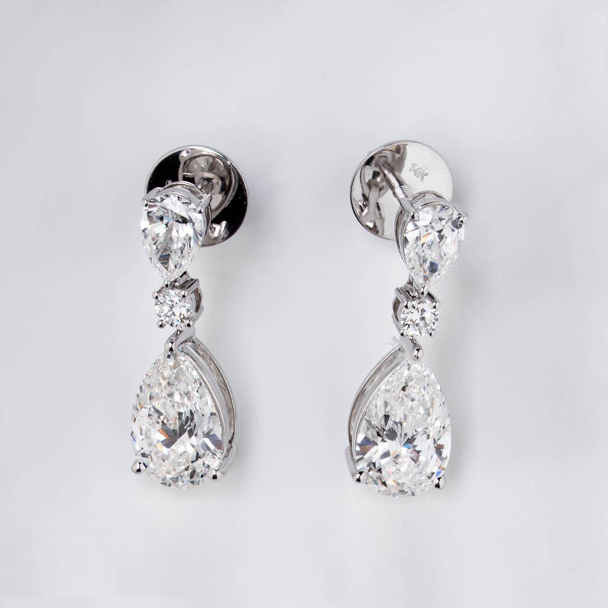 DROP EARRINGS WITH COMBINATION OF ROUND & PEAR CUT SOLITAIRE DIAMOND IN GOLD