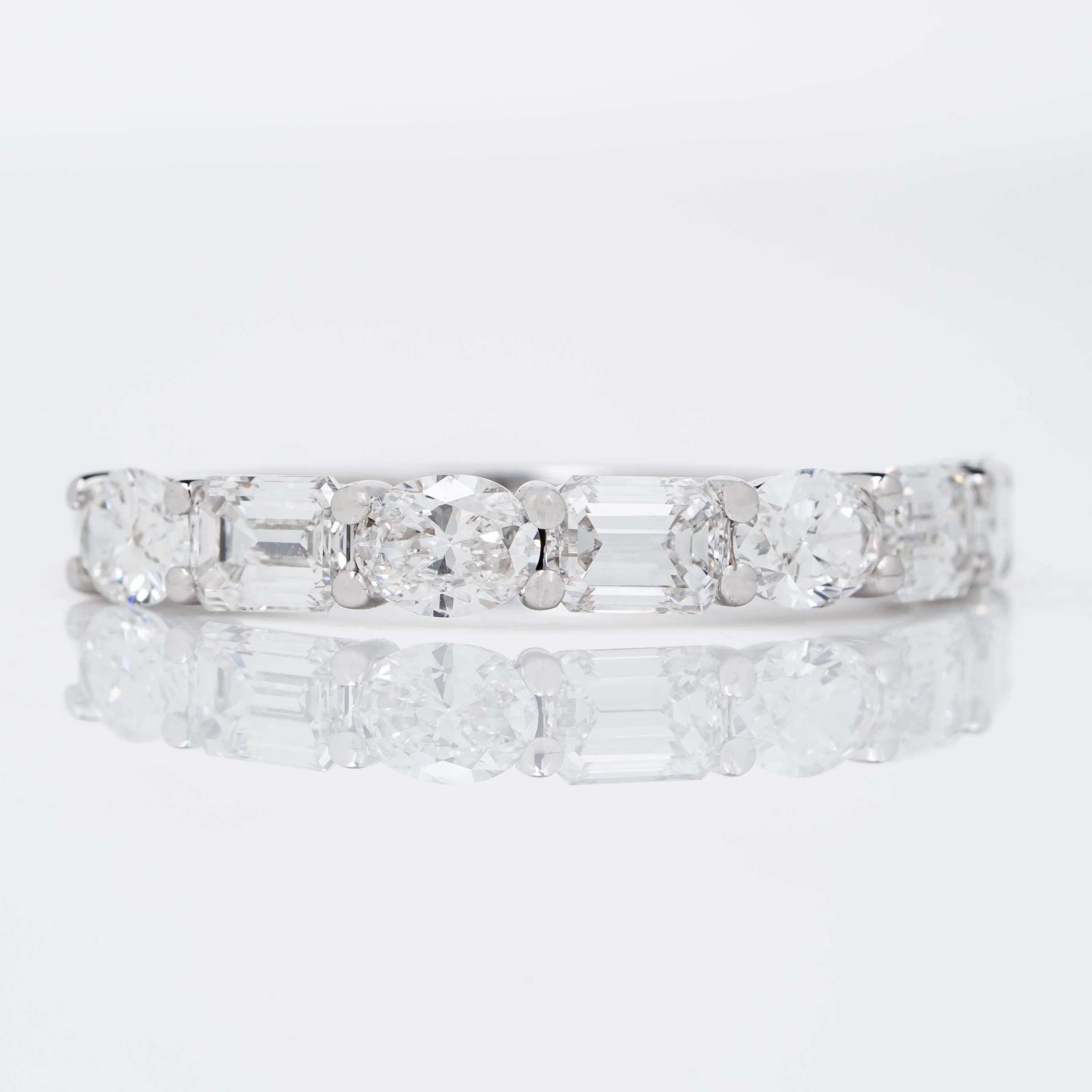 EMERALD CROWN RING EMBRACED BY OVAL CUT SOLITAIRE LAB GROWN DIAMOND
