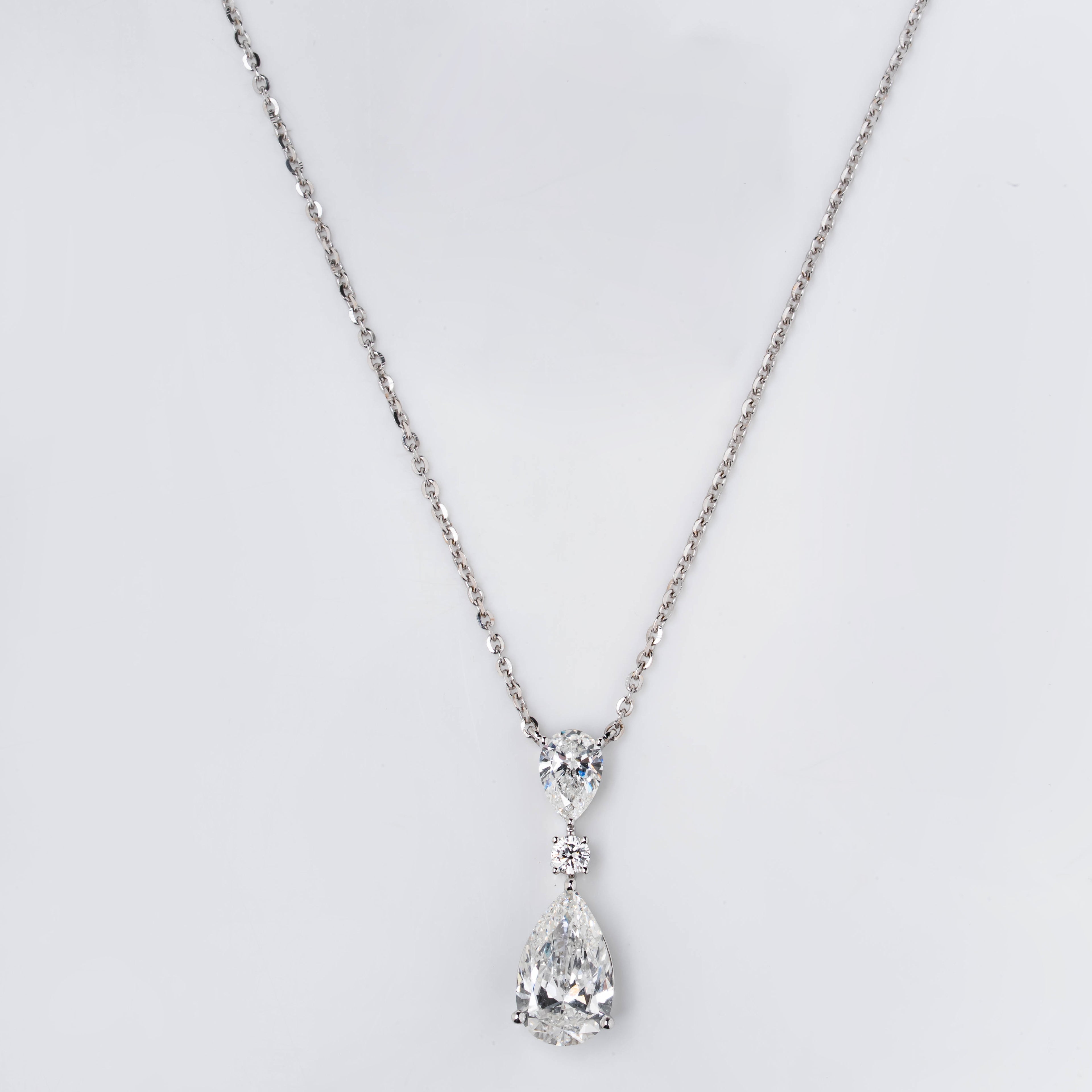 TEAR DROP PENDENT EMBRACING PERFECT PEAR AND ROUND CUT SOLITAIR DIAMOND